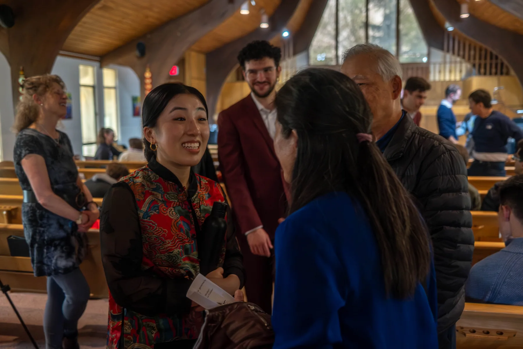 Audience and performers talking at a post-concert reception